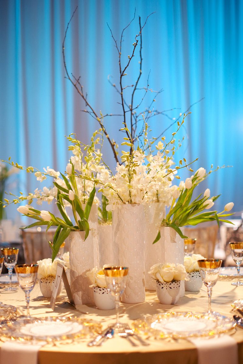 Elegant table setting with white floral centerpiece.