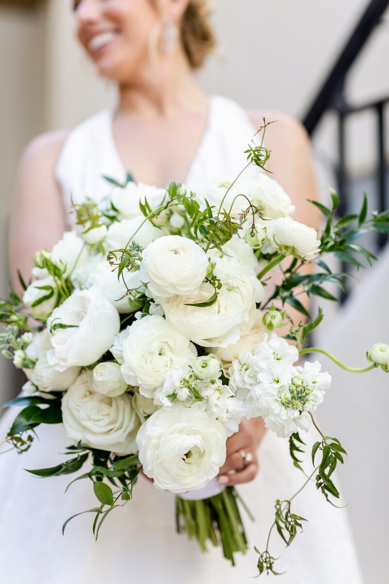 Bride holding a white flower bouquet.