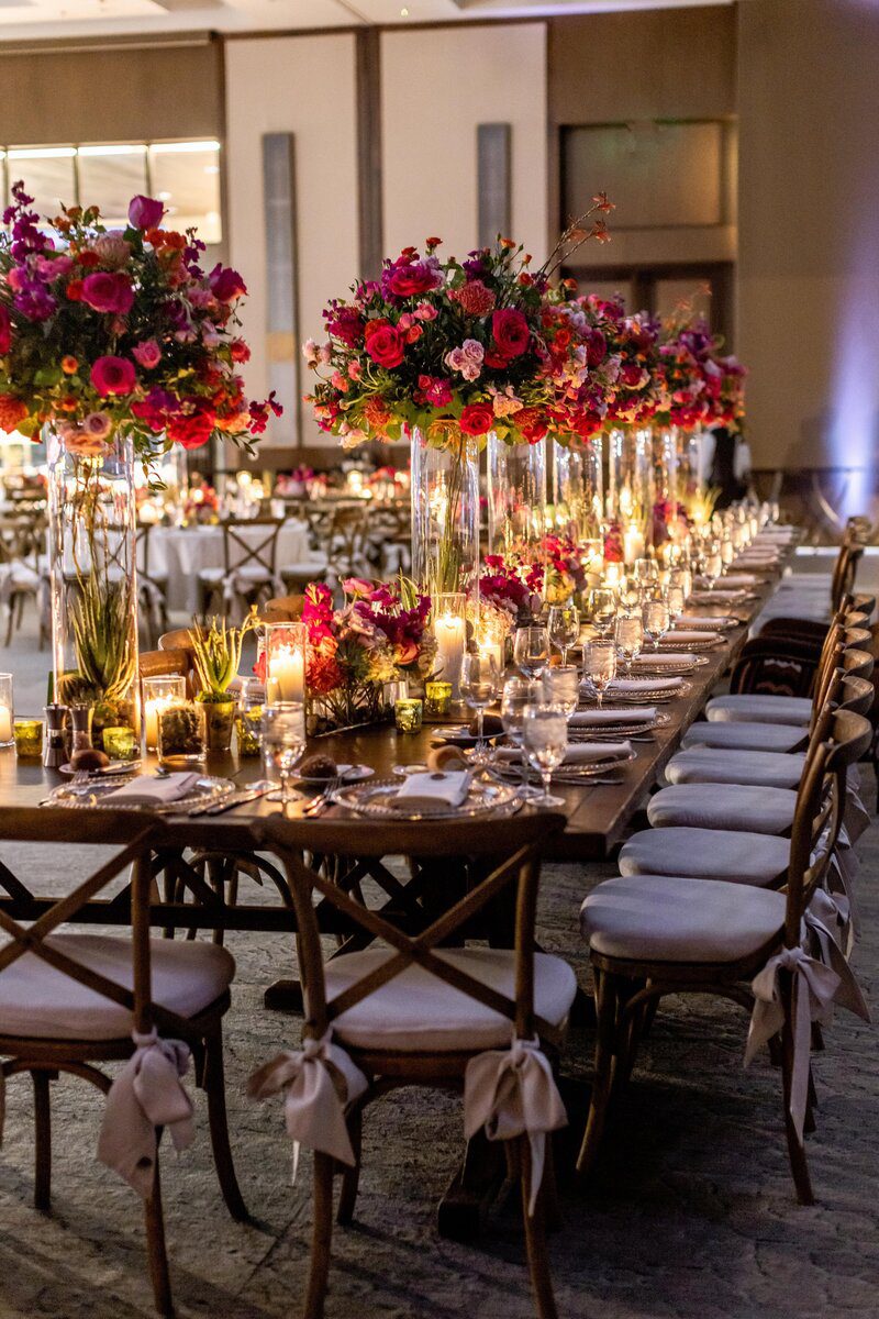 Elegant banquet table with floral centerpieces.